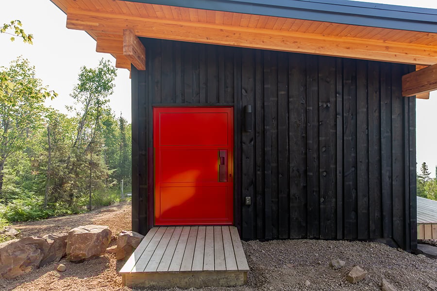 A modern front door that’s fire-engine red.