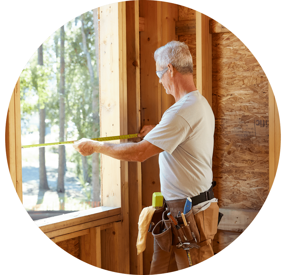 Contractor measuring a rough opening